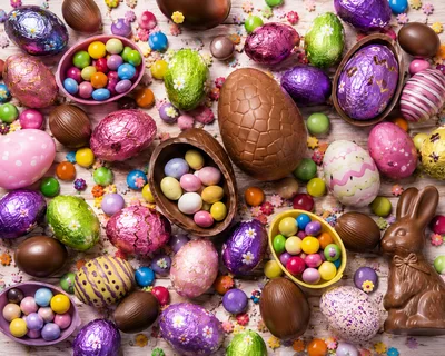 Assorted Chocolate Easter Eggs and Candy on Wooden Background