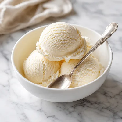 Three Scoops Of Vanilla Ice Cream In A Bowl