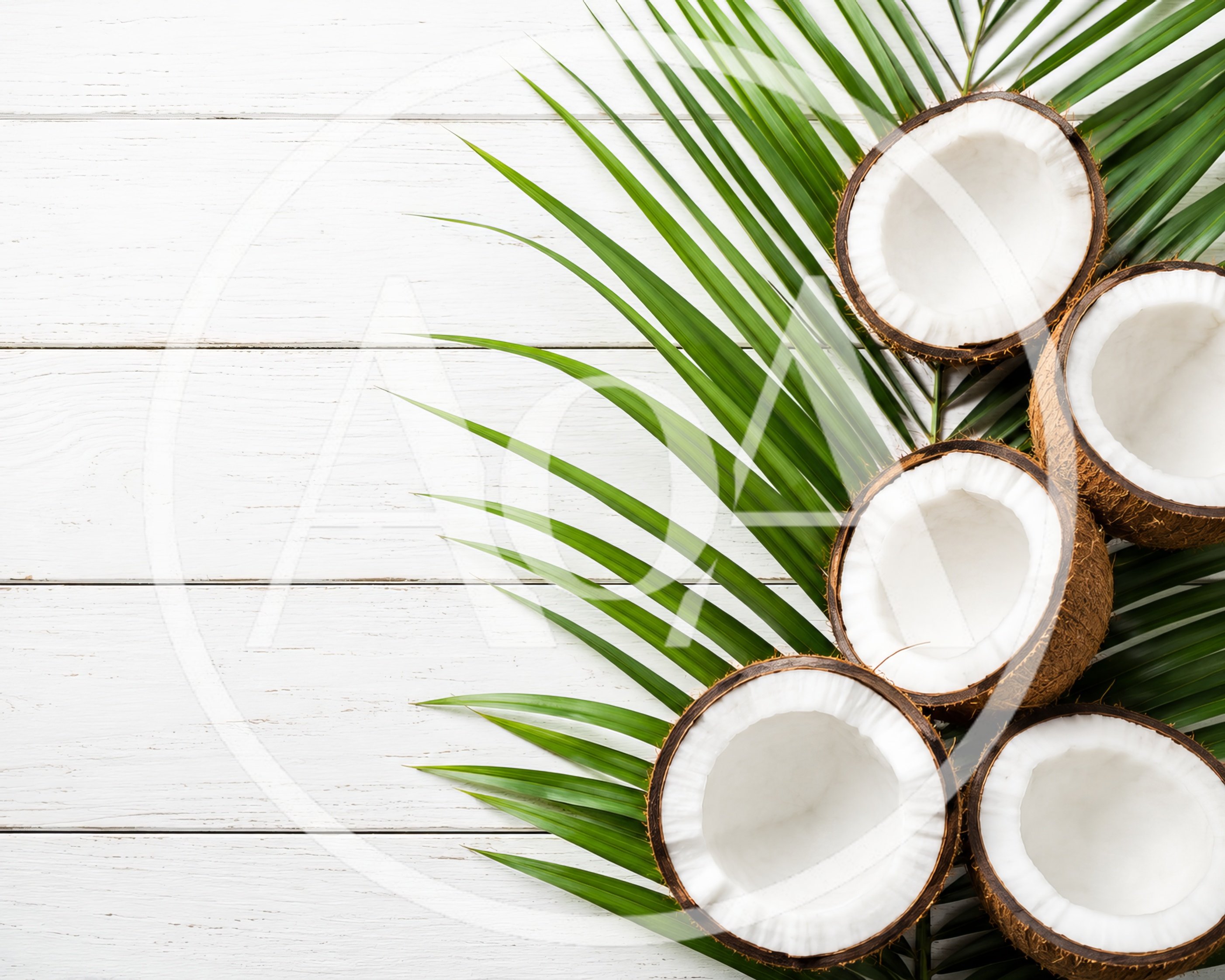 Fresh Coconut Halves On Palm Leaves And White Wood