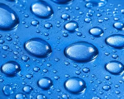 Macro Close Up Of Water Droplets On Blue Surface
