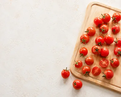 Fresh Cherry Tomatoes On A Wooden Cutting Board