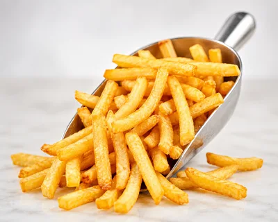 Metal Scoop Filled With Golden Crispy French Fries