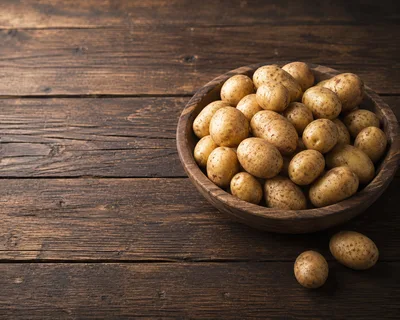 Fresh Raw Potatoes In A Wooden Bowl
