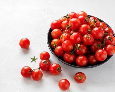 Fresh Red Cherry Tomatoes in a Black Bowl