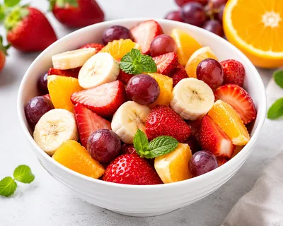 Fresh Fruit Salad Bowl with Strawberries Bananas and Grapes