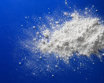 White Powder Pile on Vibrant Blue Background