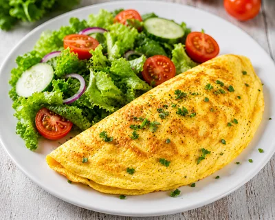 Fresh Omelet With Garden Salad On White Plate