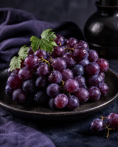 Fresh Red Grapes on a Dark Ceramic Plate