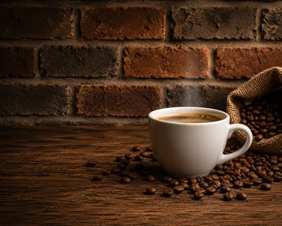 Steaming Cup Of Coffee With Roasted Beans