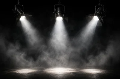 Three Stage Spotlights Shining Down Through Thick Fog