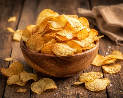 Crispy Potato Chips In A Wooden Bowl