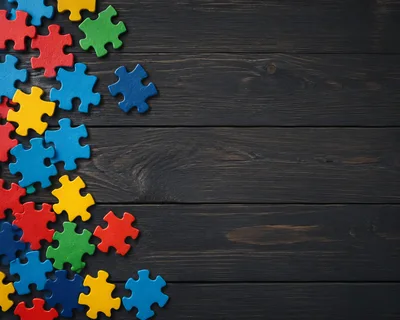 Colorful Jigsaw Puzzle Pieces on Dark Wooden Background
