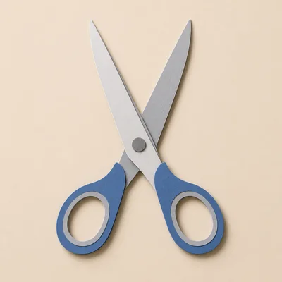 Blue Handled Scissors Isolated On Beige Background