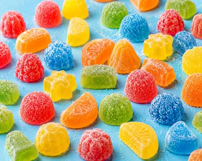 Assorted Colorful Gummy Candies on Blue Background