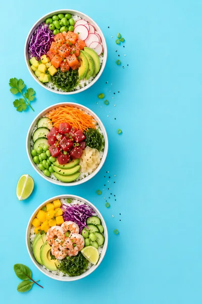 Three Healthy Poke Bowls On Blue Background