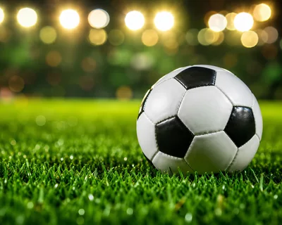 Soccer Ball Resting On Green Stadium Grass