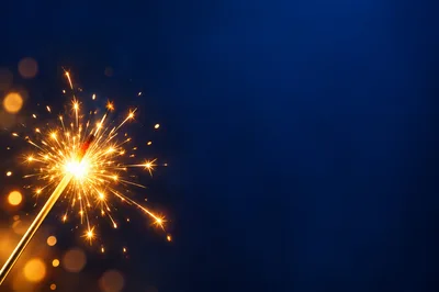 Sparkler Burning Brightly Against A Deep Blue Background