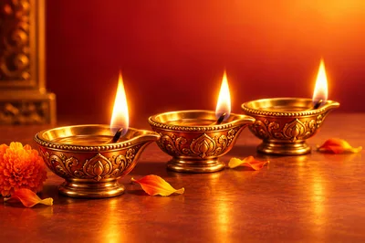 Three Traditional Brass Oil Lamps Lit For Diwali