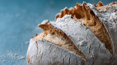 Freshly Baked Sourdough Bread Loaf On Blue Surface
