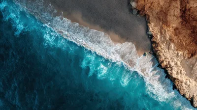 Aerial View Of Waves Crashing On Rocky Beach