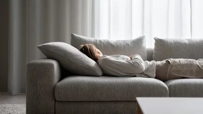 Woman Resting On A Comfortable Gray Sofa