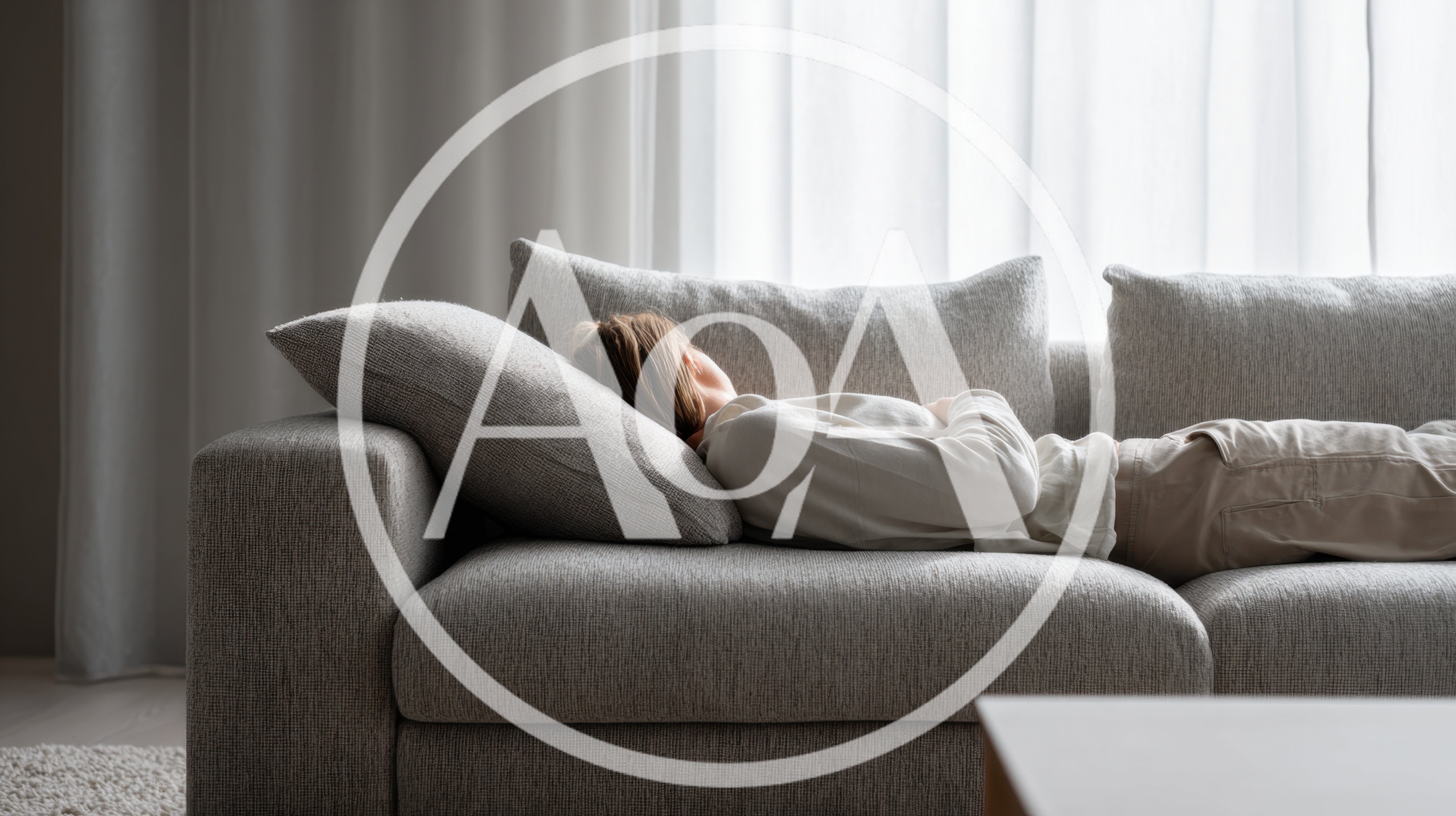 Woman Resting On A Comfortable Gray Sofa