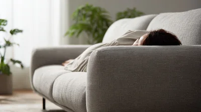 Woman Resting On A Comfortable Gray Sofa