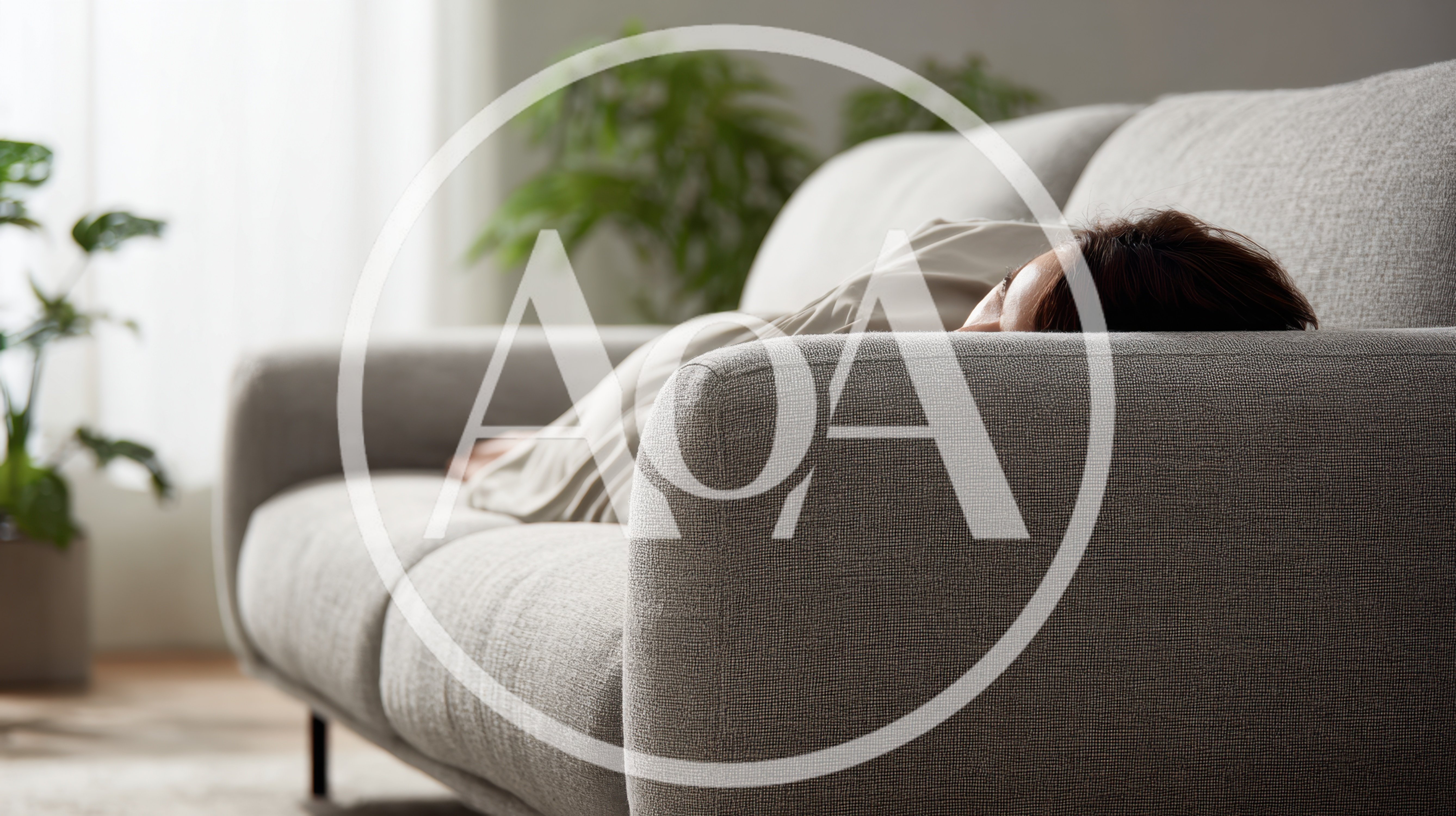 Woman Resting On A Comfortable Gray Sofa