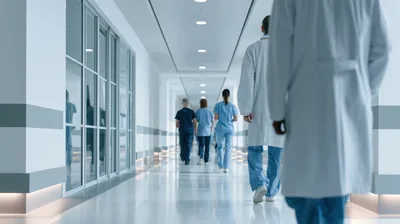 Medical Professionals Walking Down Hospital Corridor