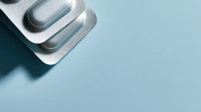 Silver Blister Packs of Pills on Blue Background