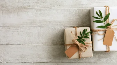 Two Wrapped Gift Boxes on Rustic Wooden Background