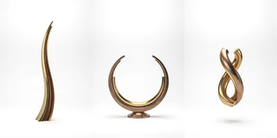 Three Abstract Metallic Sculptures On White Background