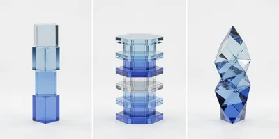 Three Abstract Blue Glass Sculptures On White Background