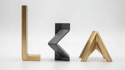 Three Modern Metal Furniture Legs On White Background