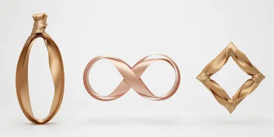 Gold Ribbon Shapes Floating On White Background