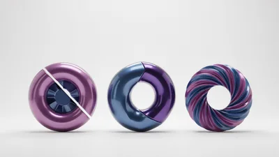 Three Abstract Metallic Torus Shapes On White Background