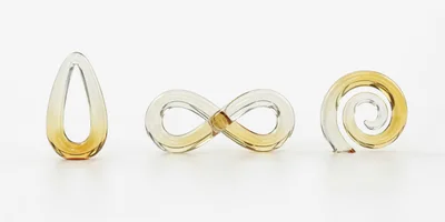 Three Abstract Glass Sculptures On White Background