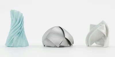 Three Abstract Geometric Sculptures On White Background