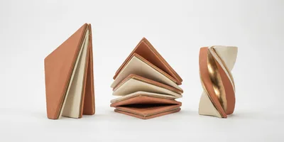 Three Modern Ceramic Sculptures On White Background
