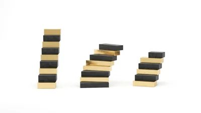 Three Stacks Of Alternating Gold And Black Blocks