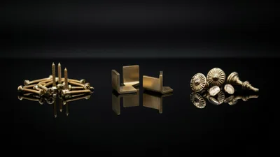 Brass Hardware Components Arranged On Reflective Black Surface