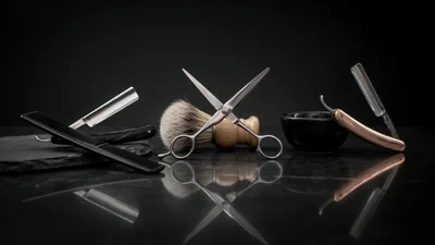 Professional Barber Tools Arranged On A Reflective Surface