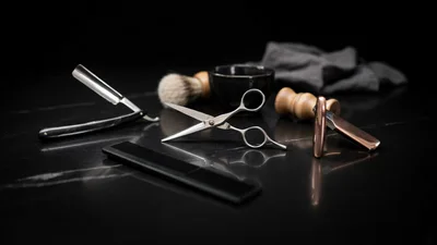 Professional Barber Tools Arranged on Black Marble Surface