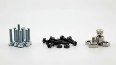 Assorted Metal Bolts and Nuts on White Background