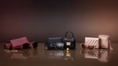 Luxury Fashion Accessories Arranged on Reflective Surface
