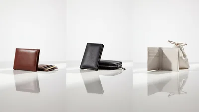Three Luxury Leather Wallets Displayed On White Surface