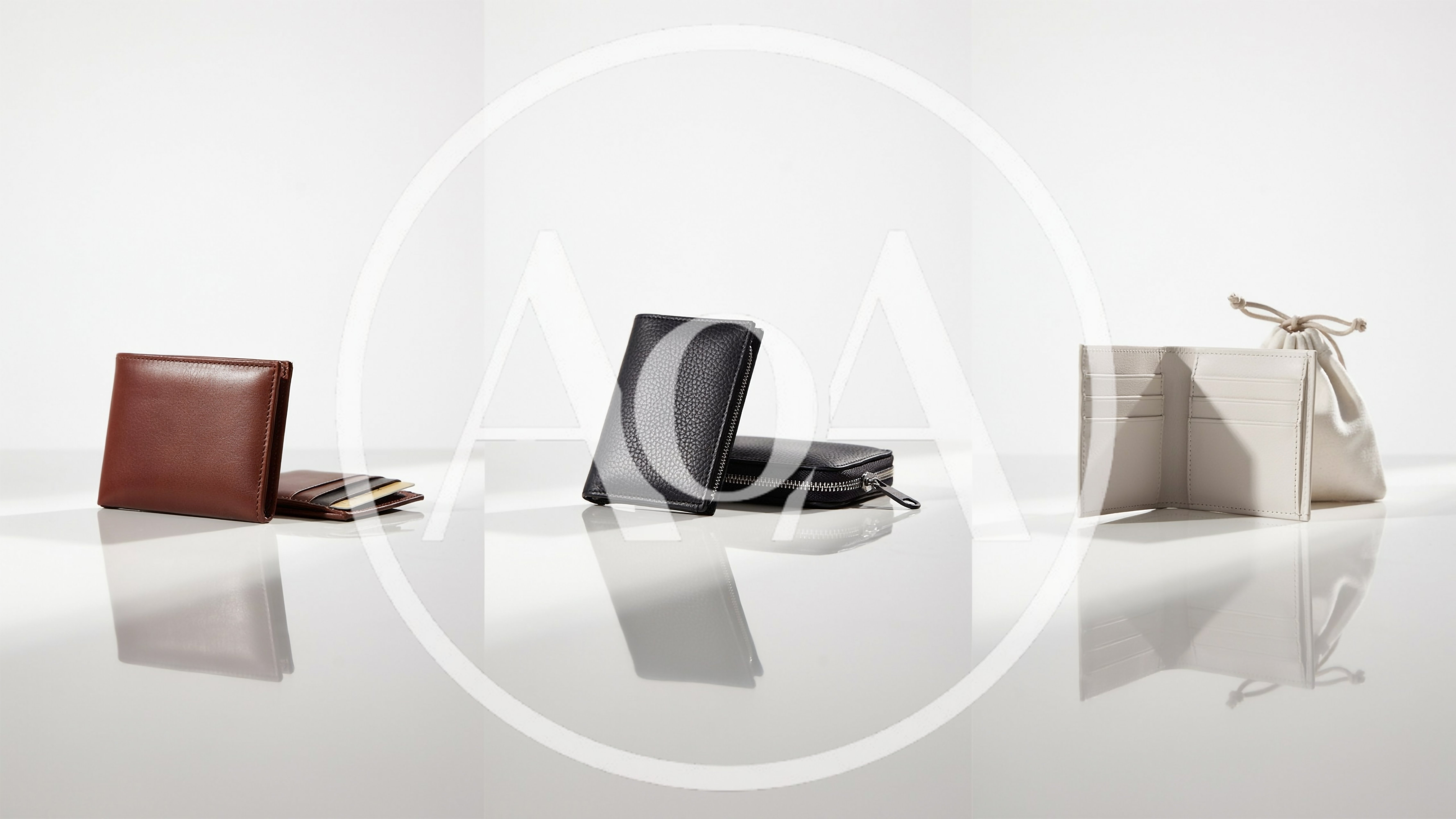 Three Luxury Leather Wallets Displayed On White Surface