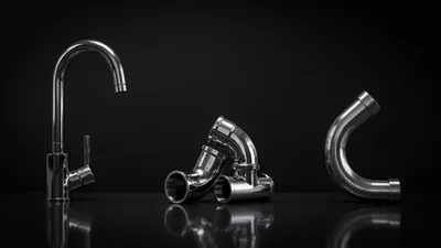 Chrome Plumbing Fixtures and Pipe Fittings on Black Background