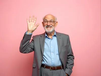 Senior Man Waving Hello Against Pink Background