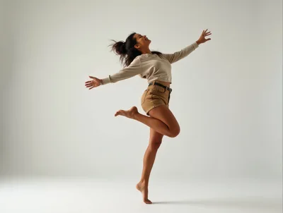Young Woman Jumping With Joy In Studio